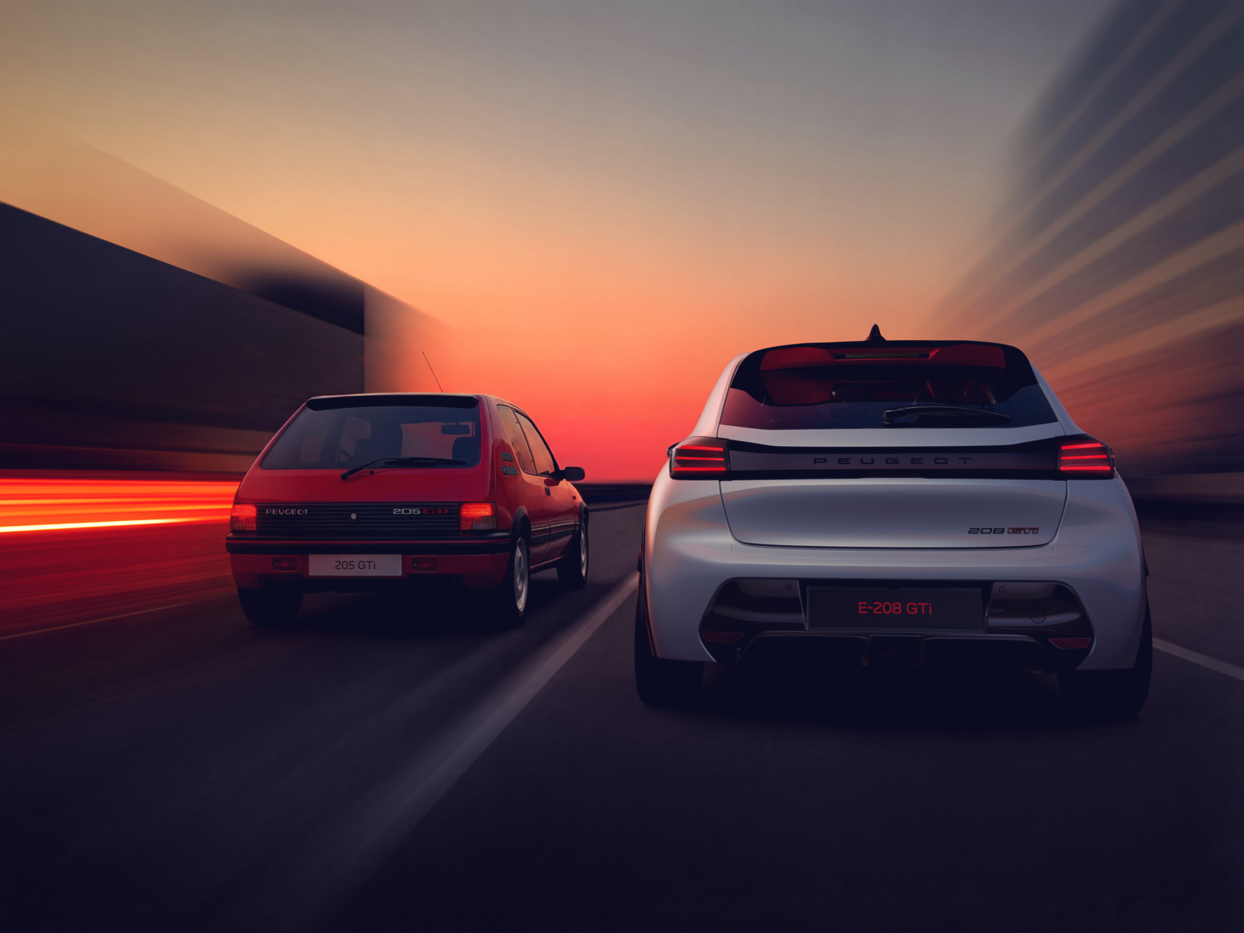 Peugeot E-208 GTi in Weiß neben dem roten 205 GTi – Generationenvergleich von hinten
