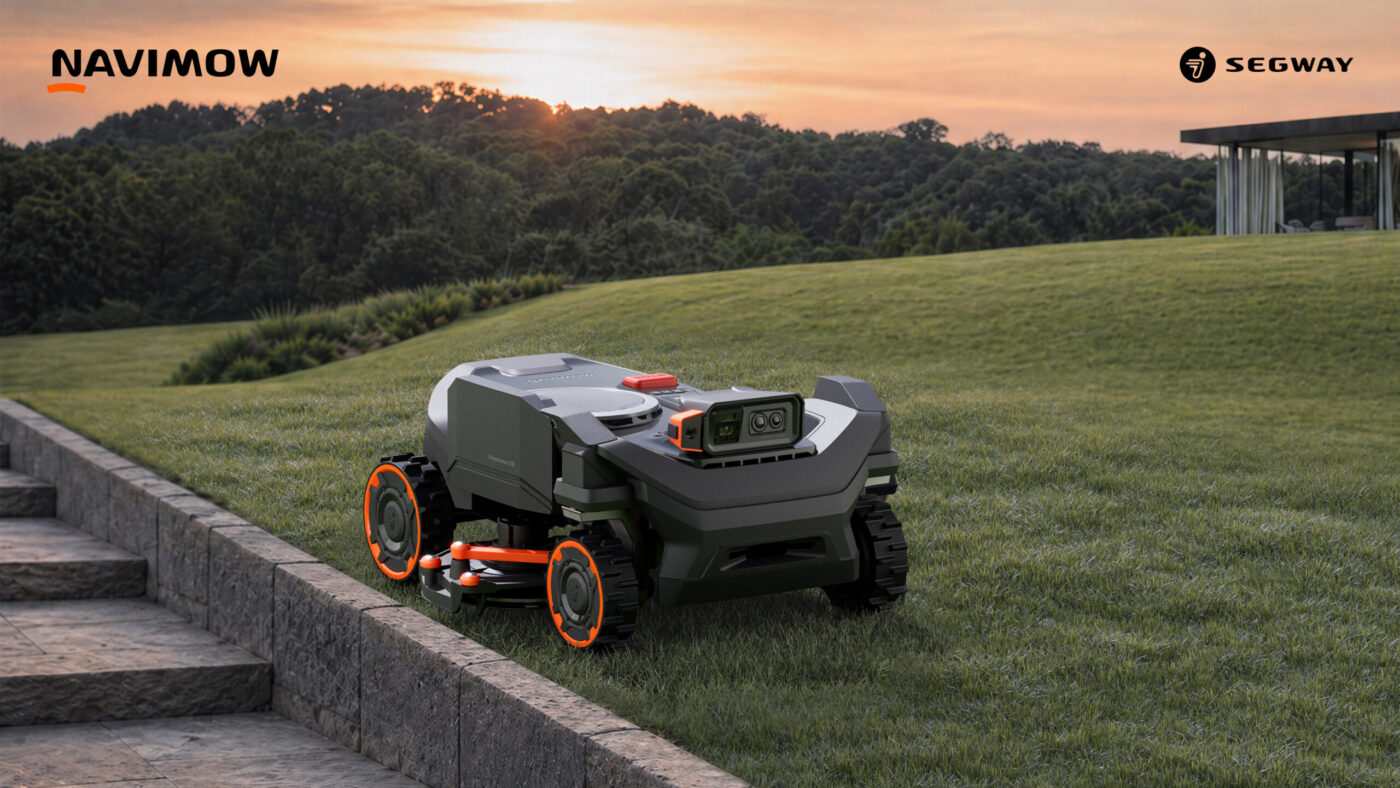 Segway Navimow H5 Pro Mähroboter mit Allradantrieb und Frontsensoren auf einer Rasenfläche bei Sonnenuntergang