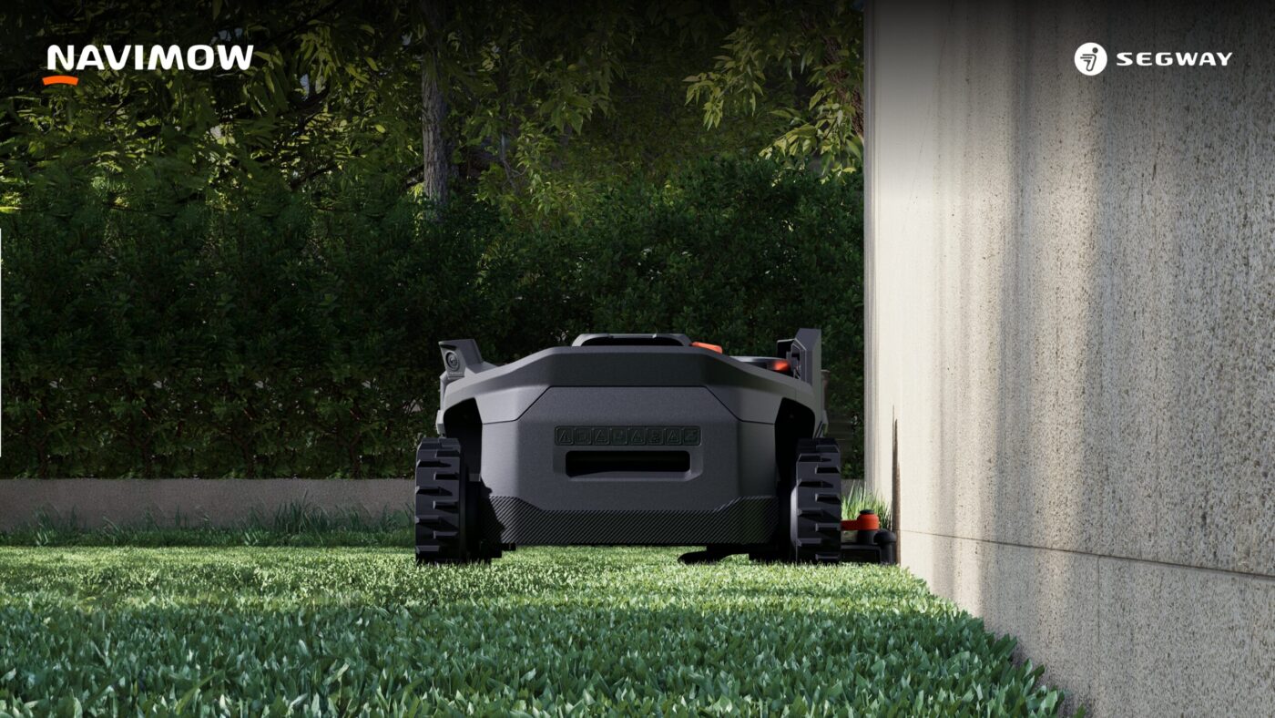 Segway Navimow H5 Pro Mähroboter von hinten auf Rasen neben Betonwand