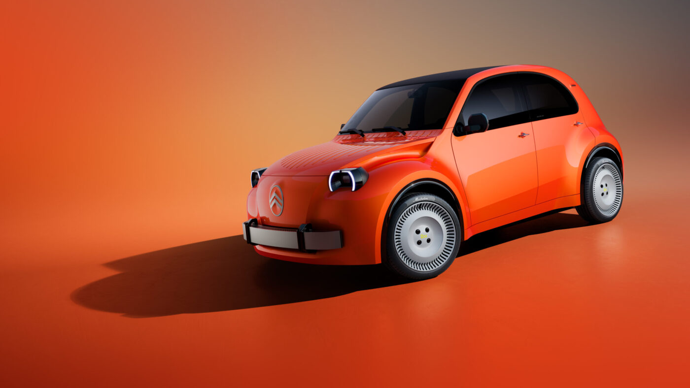 Citroën 2CV Elektro-Konzeptfahrzeug in Orange mit charakteristischen runden Scheinwerfern und weißen Radkappen