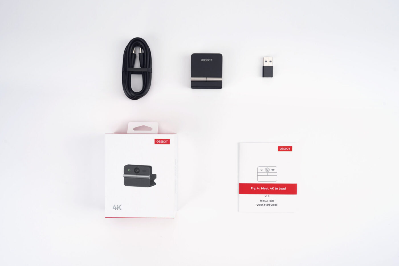 Lieferumfang der OBSBOT Meet Flip mit Kamera, USB-Kabel, Adapter, Verpackung und Kurzanleitung